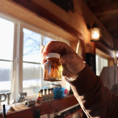 small bottle of maple syrup catching the light
