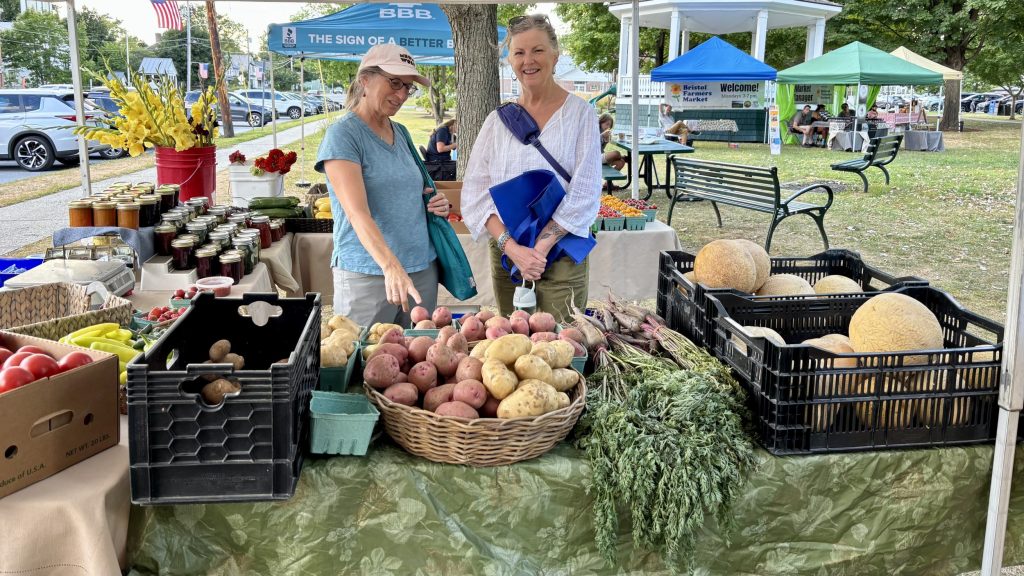 swift house inn bristol farmers market | Swift House Inn two women at a farmers market in bristol vermont
